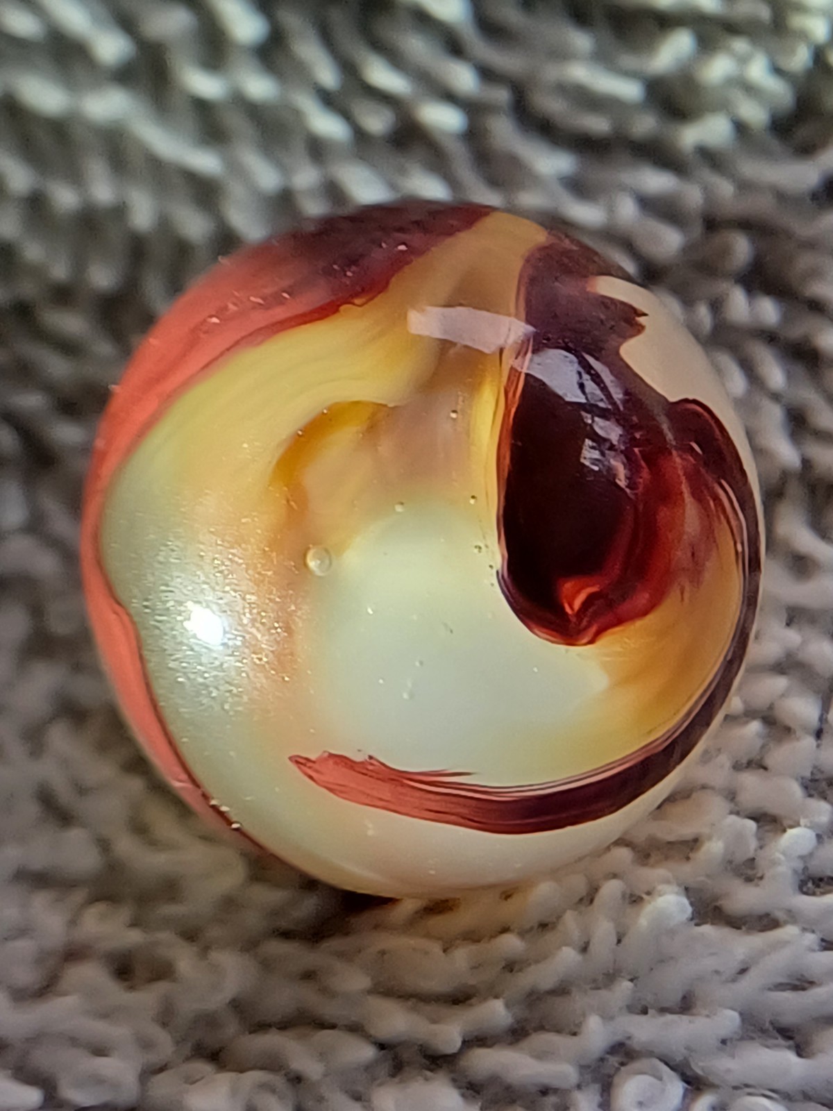 “Golden Onyx Oxblood” .71 Shiney wet dead mint. Very old, rare marble. 1920s (2)