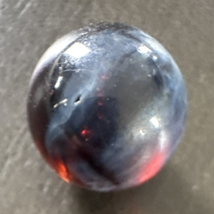 Marble. Rare looking. Glass swirl style. Dark blue/black with red.