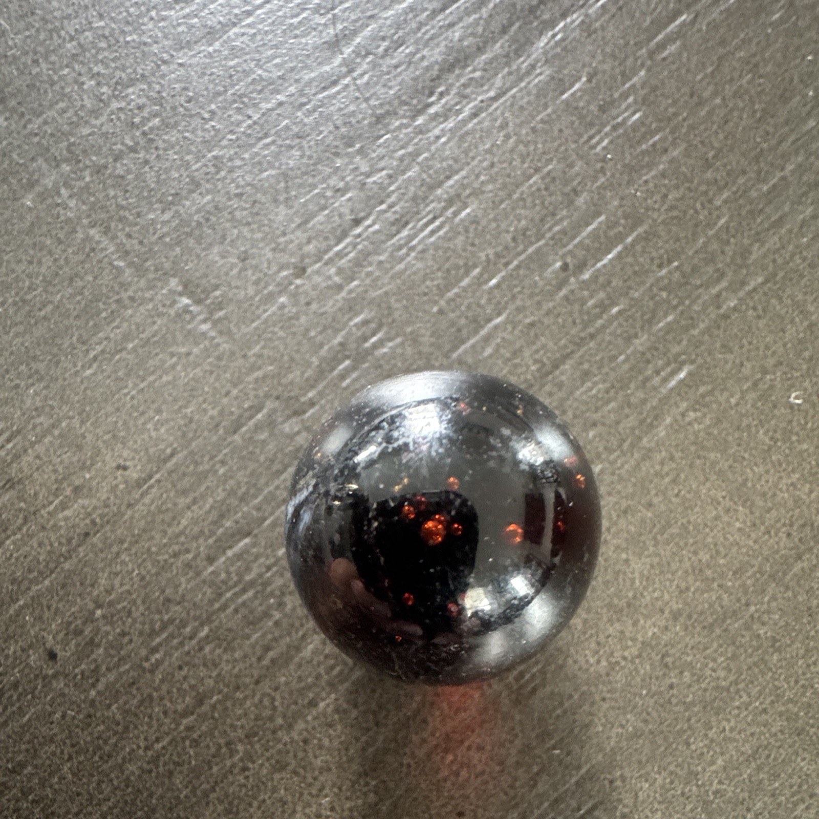 Marble. Rare looking. Glass swirl style. Dark blue/black with red.