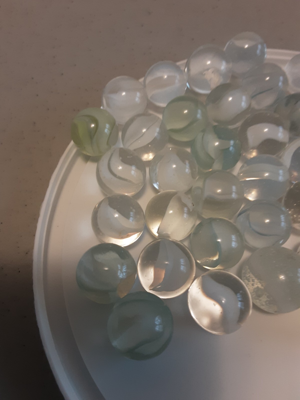 42 Vintage white/green toned cats eye marbles, from 1960’s