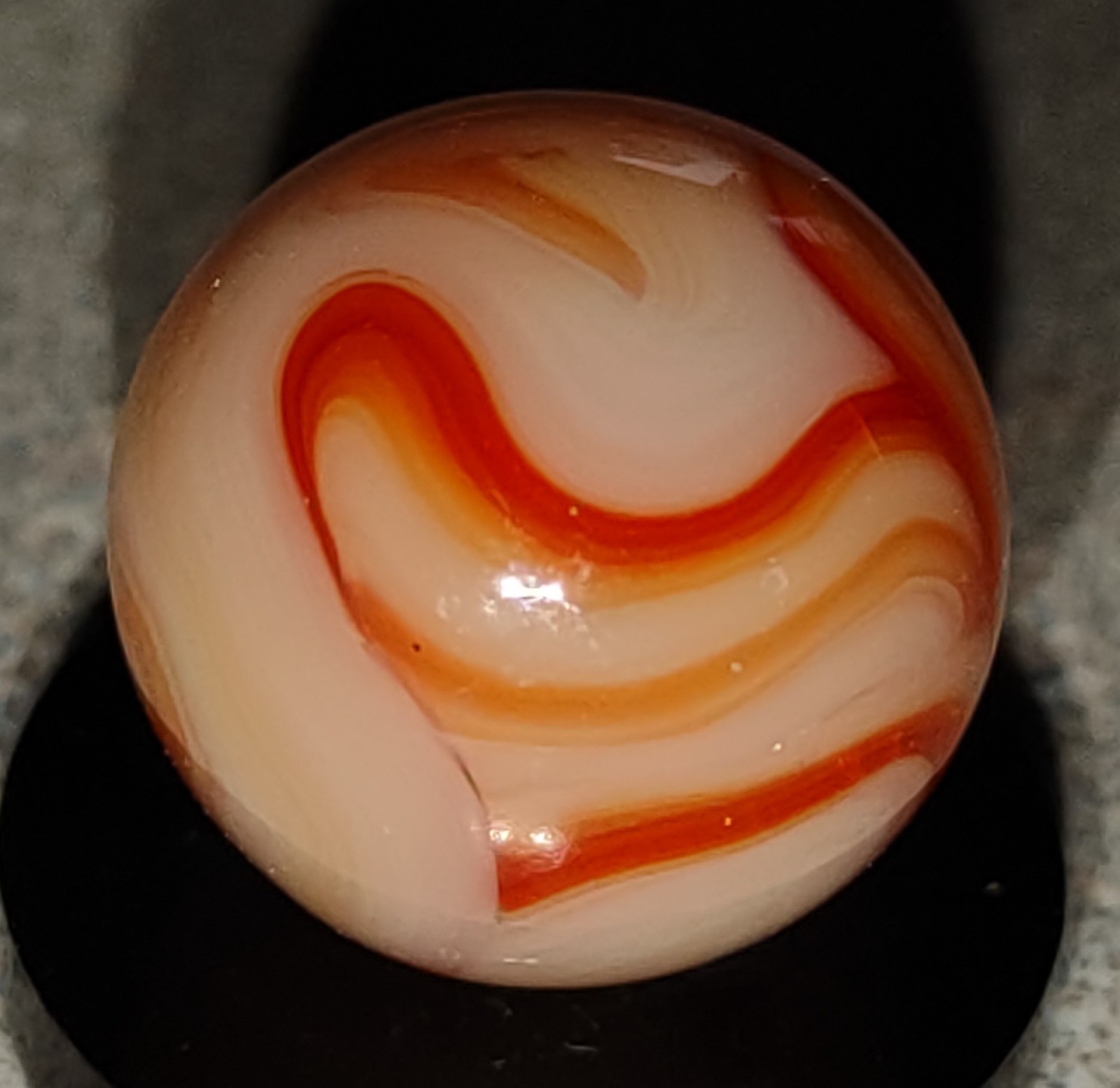 West Virginia Swirl marble-.59″ Mint-, red/orange swirls, mossy Transl. base-***