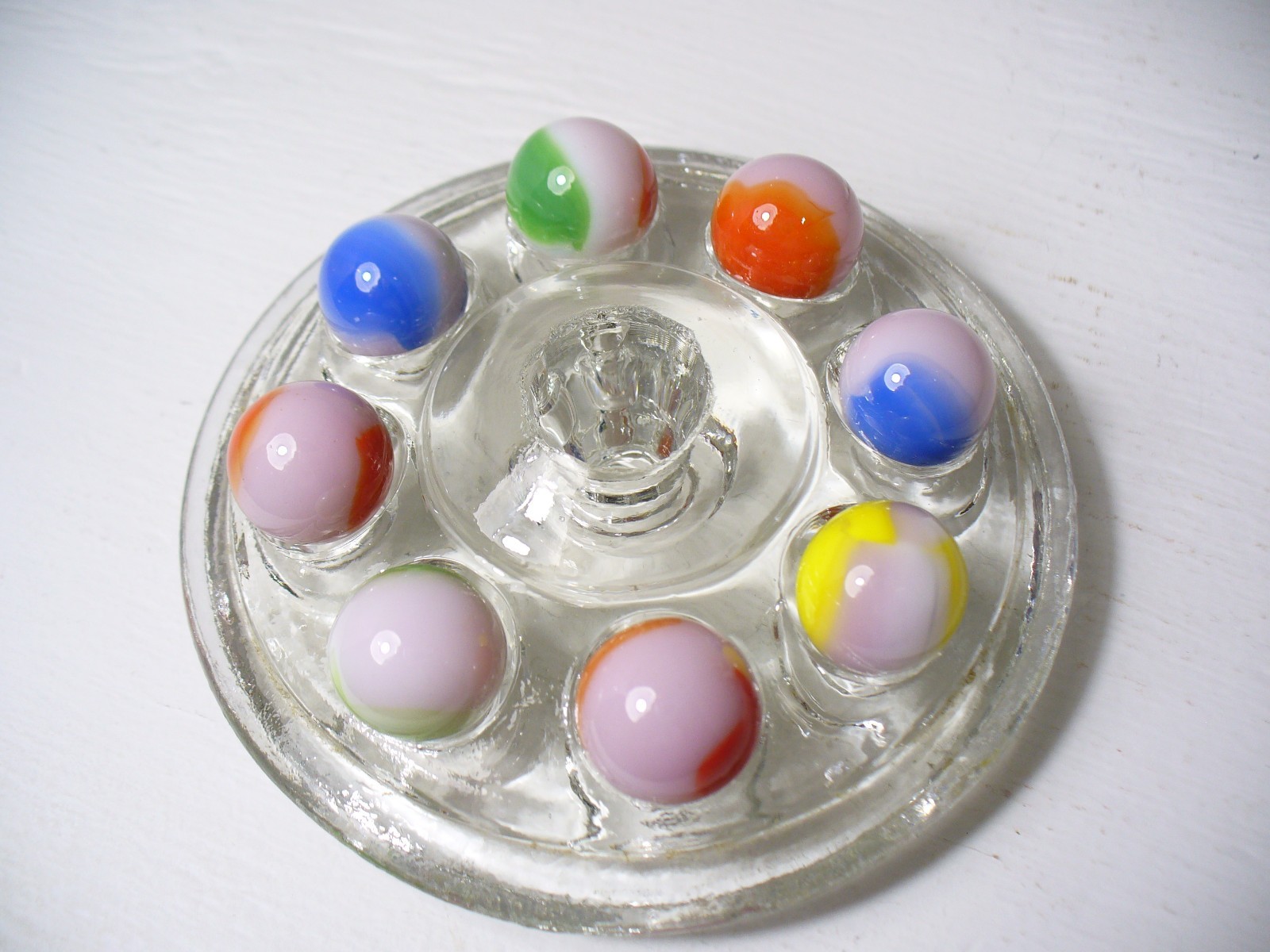 #916 Vintage Marble King Rainbows 8 Pieces all are on a Pink base.