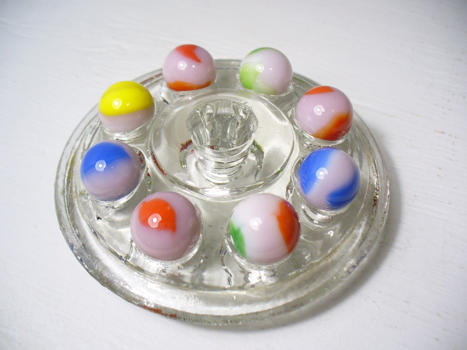 #916 Vintage Marble King Rainbows 8 Pieces all are on a Pink base.