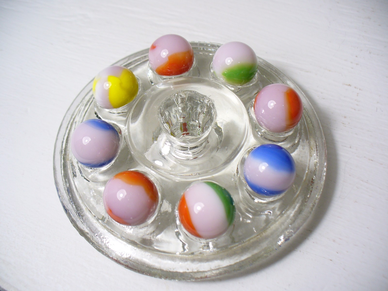 #916 Vintage Marble King Rainbows 8 Pieces all are on a Pink base.