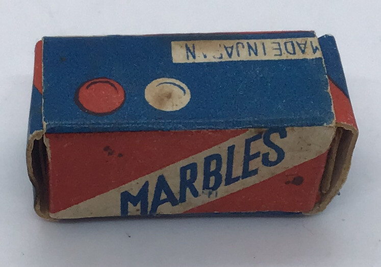 Vintage marble box with 2 marbles. 1”X 1/2” in good condition. Made in Japan.