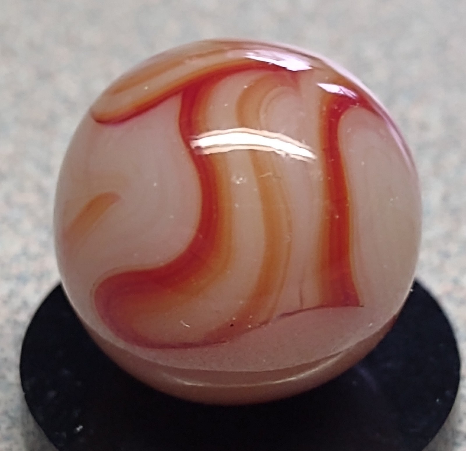 West Virginia Swirl marble-.59″ Mint-, red/orange swirls, mossy Transl. base-***