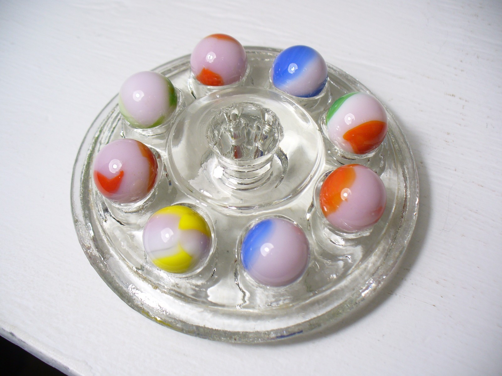 #916 Vintage Marble King Rainbows 8 Pieces all are on a Pink base.