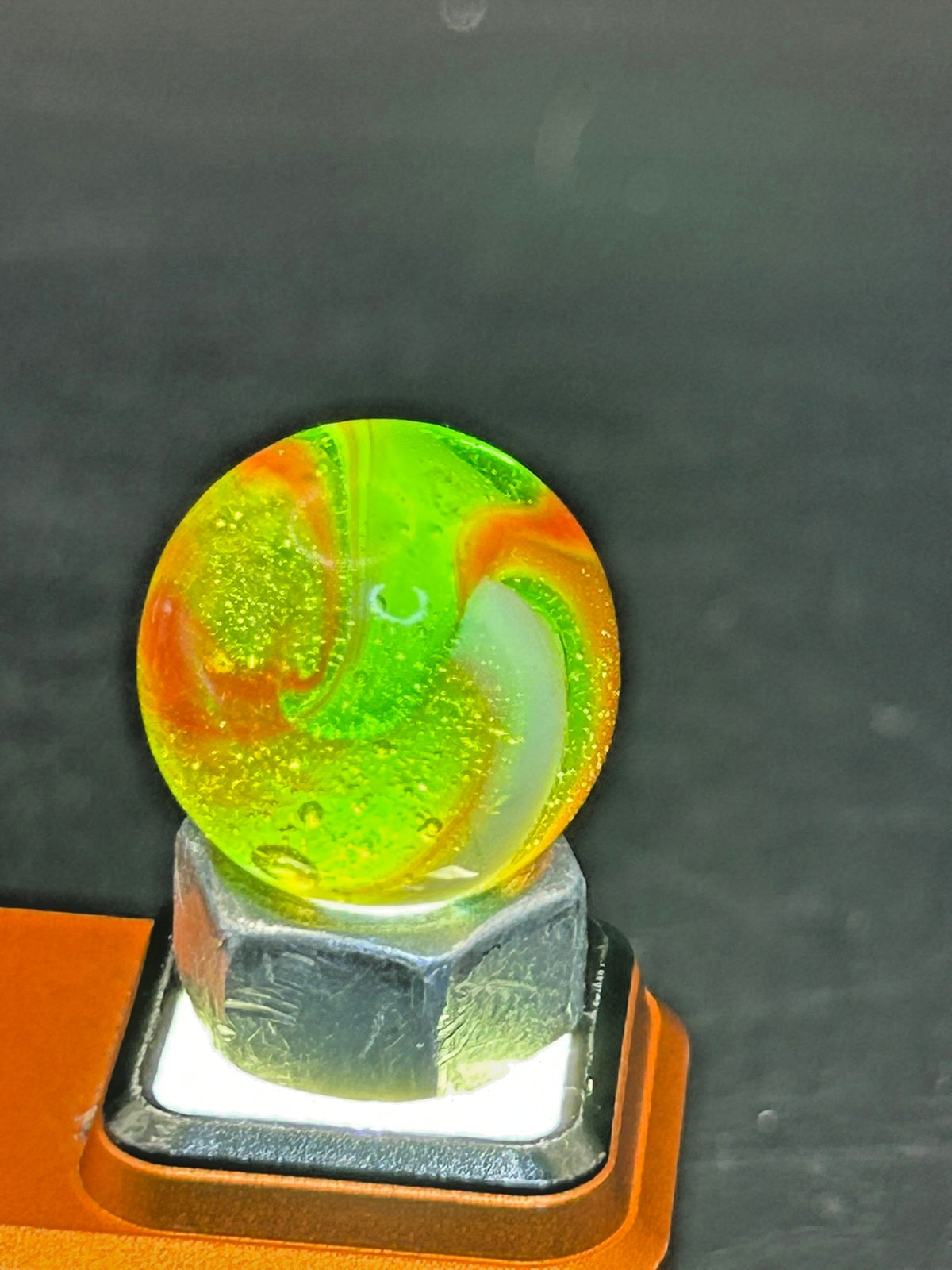 Peltier NLR Tri-Lite Marble, Green Base/Orange-Red Ribbon, UV Reactive, .63″ P28