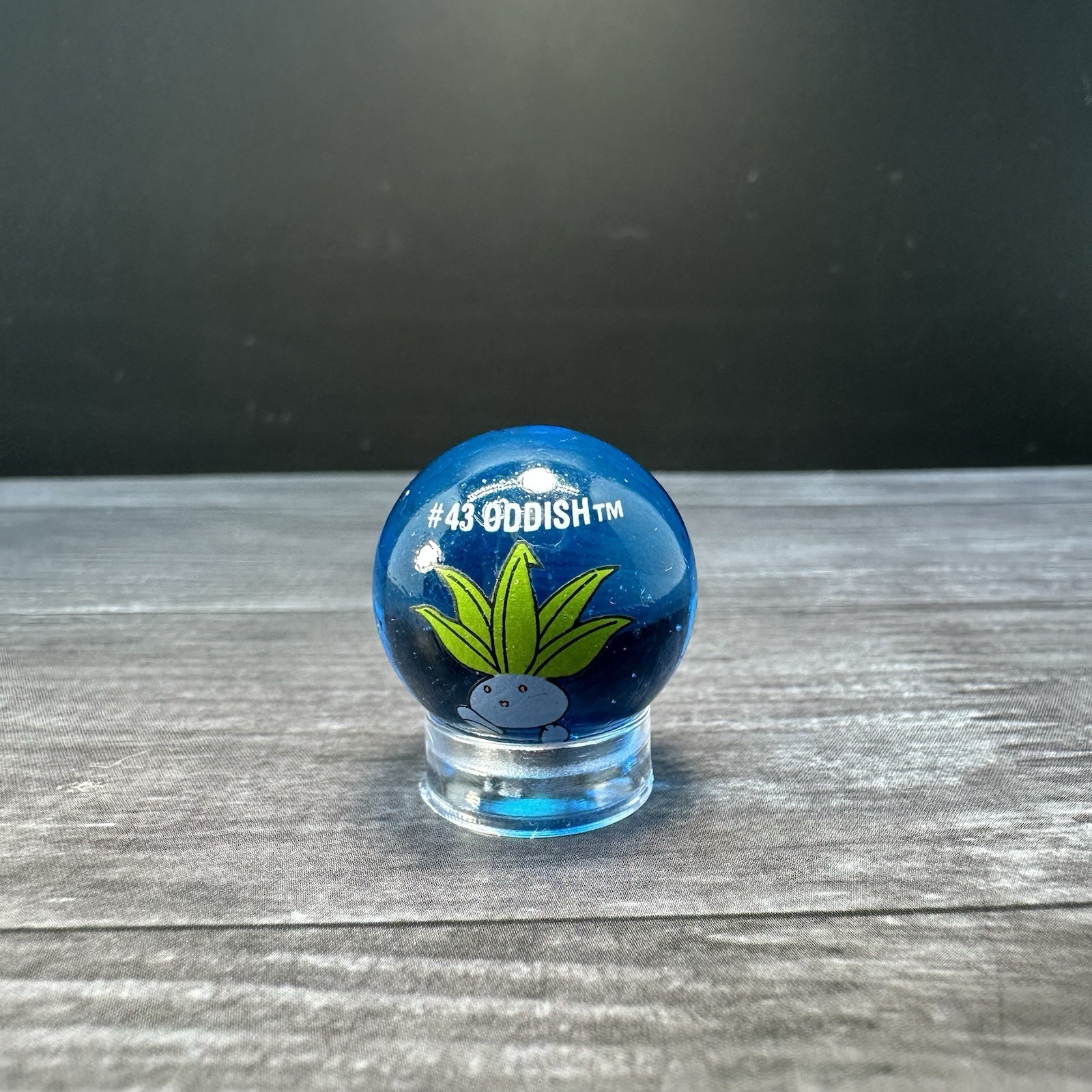 Vintage ToyBiz Pokemon Marble Oddish #43 Glass Marble Clear Blue