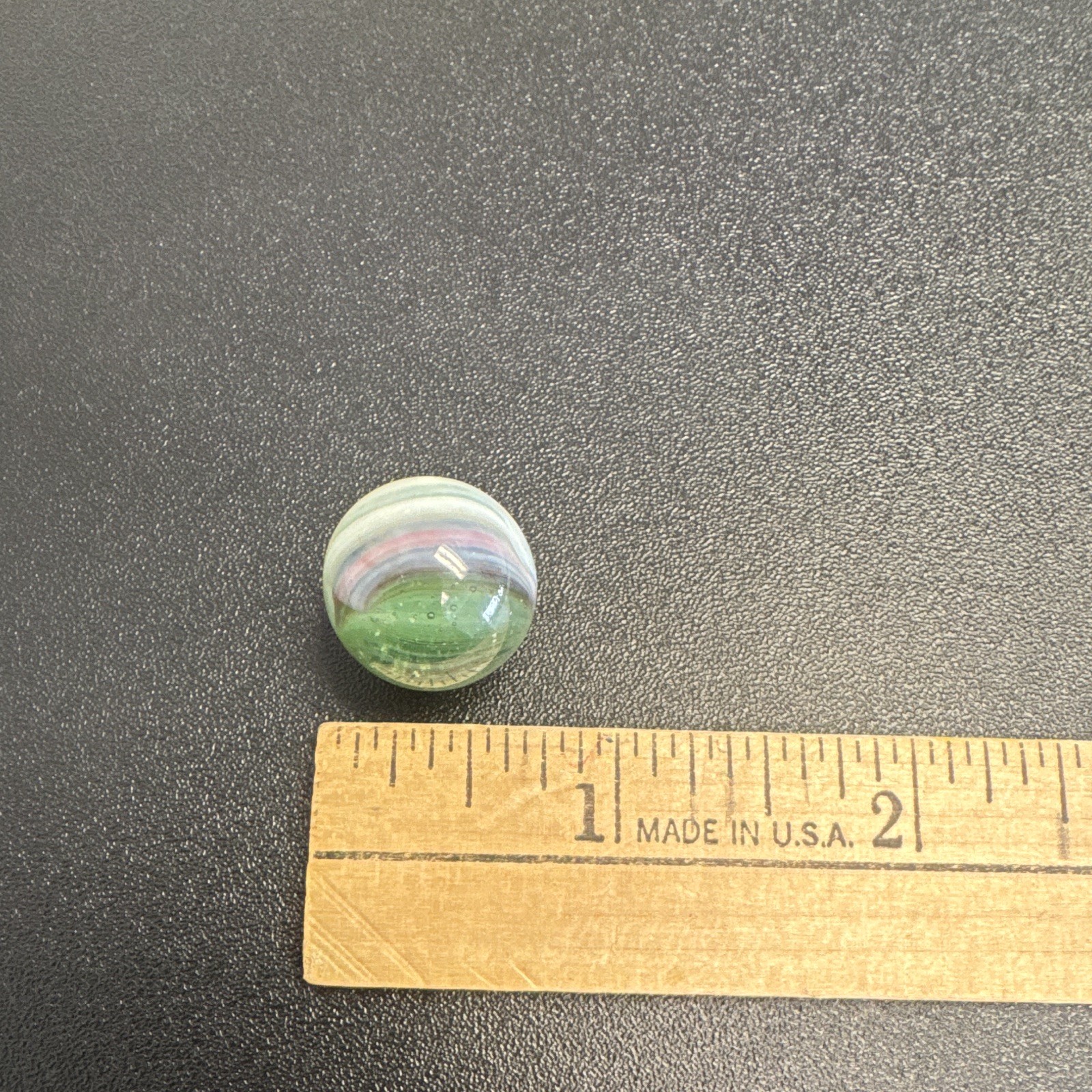 Marble. Glass. Swirl. Many colors- Green, white, blue, pinkish purple