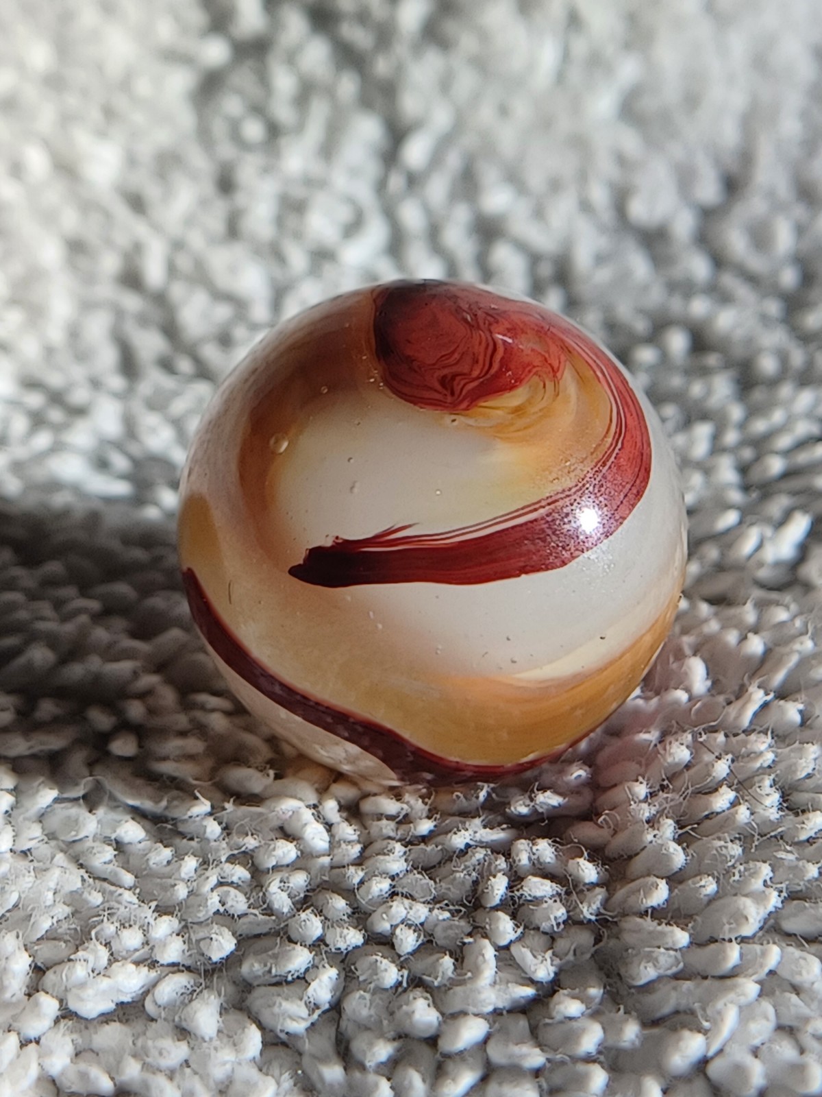 “Golden Onyx Oxblood” .71 Shiney wet dead mint. Very old, rare marble. 1920s (2)