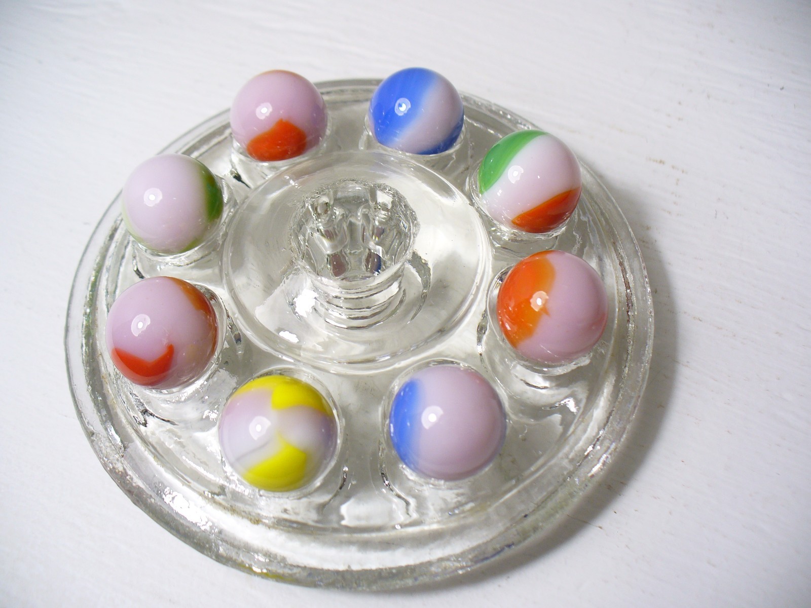 #916 Vintage Marble King Rainbows 8 Pieces all are on a Pink base.