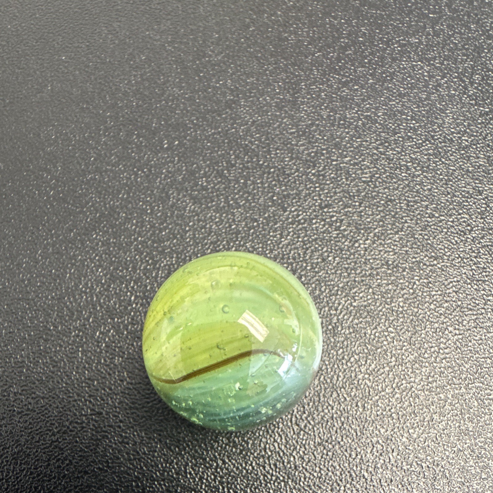 Marble. Glass. Swirl. Many colors- Green, white, blue, pinkish purple