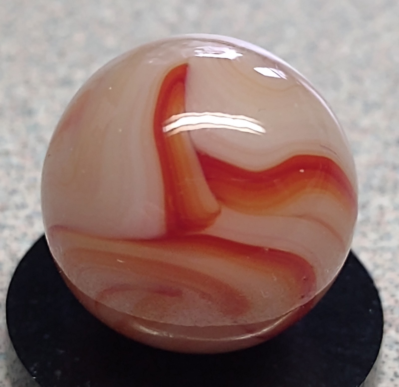 West Virginia Swirl marble-.59″ Mint-, red/orange swirls, mossy Transl. base-***