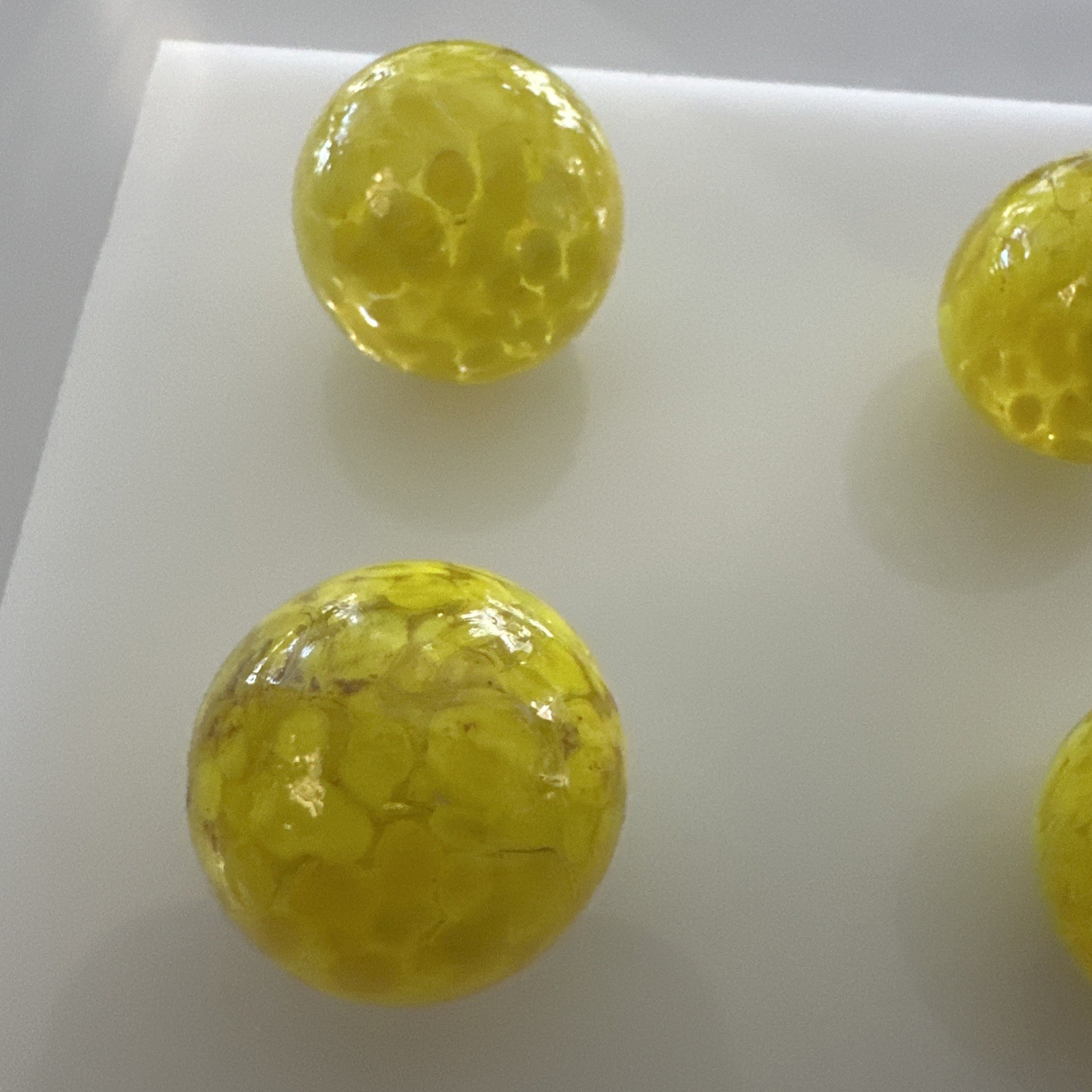 Glass Marbles Game Shooters 1″ 9 pcs Clear w/yellow spots 26mm