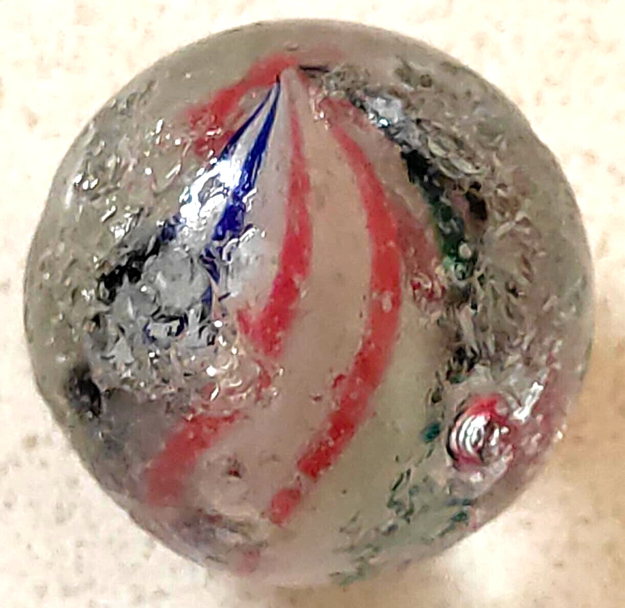 TOY MARBLE 1.1” marble trilevel ,solid core, 4 panel ribbon swirl, requ ground