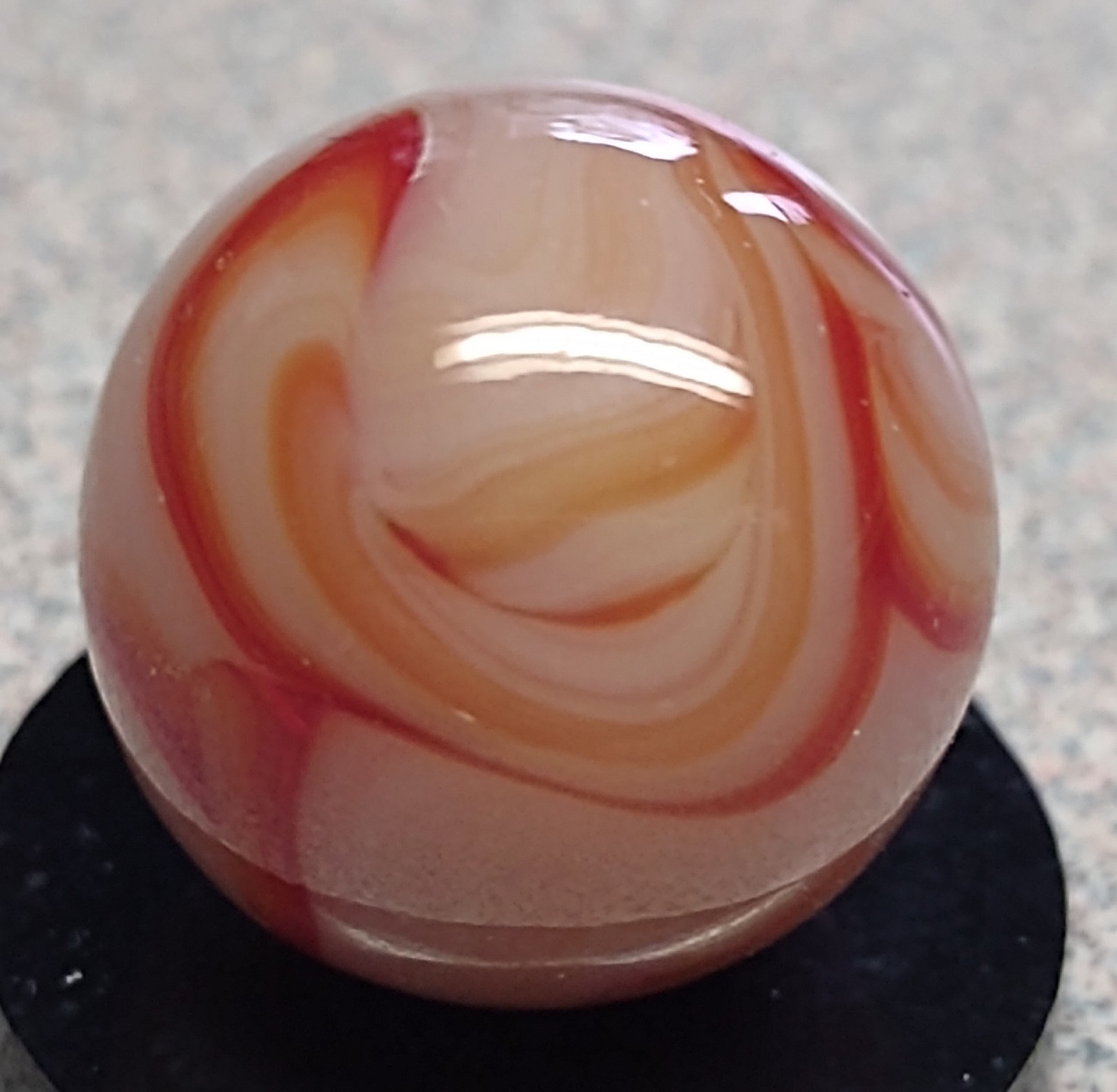 West Virginia Swirl marble-.59″ Mint-, red/orange swirls, mossy Transl. base-***