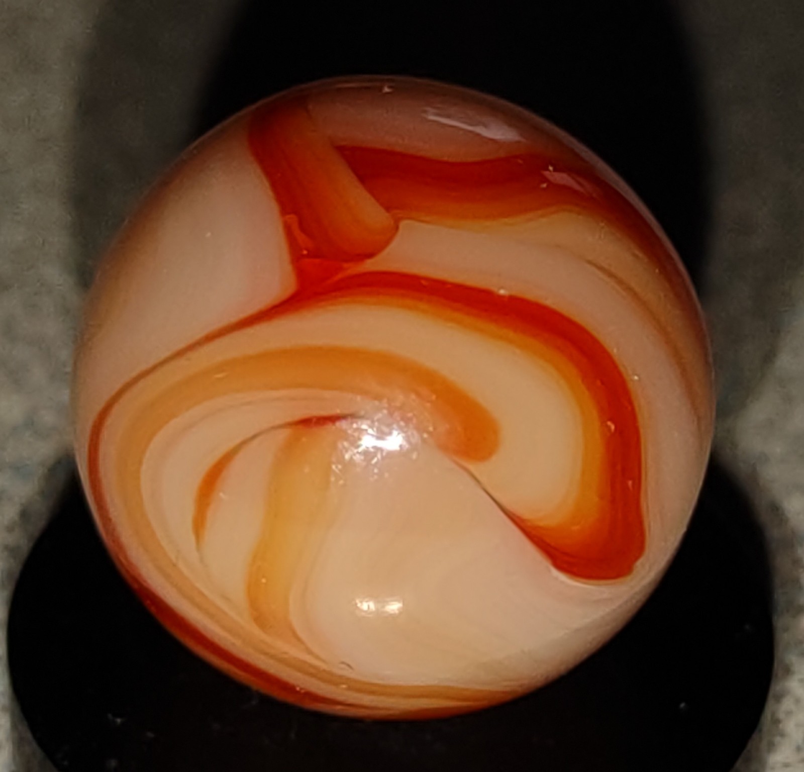 West Virginia Swirl marble-.59″ Mint-, red/orange swirls, mossy Transl. base-***