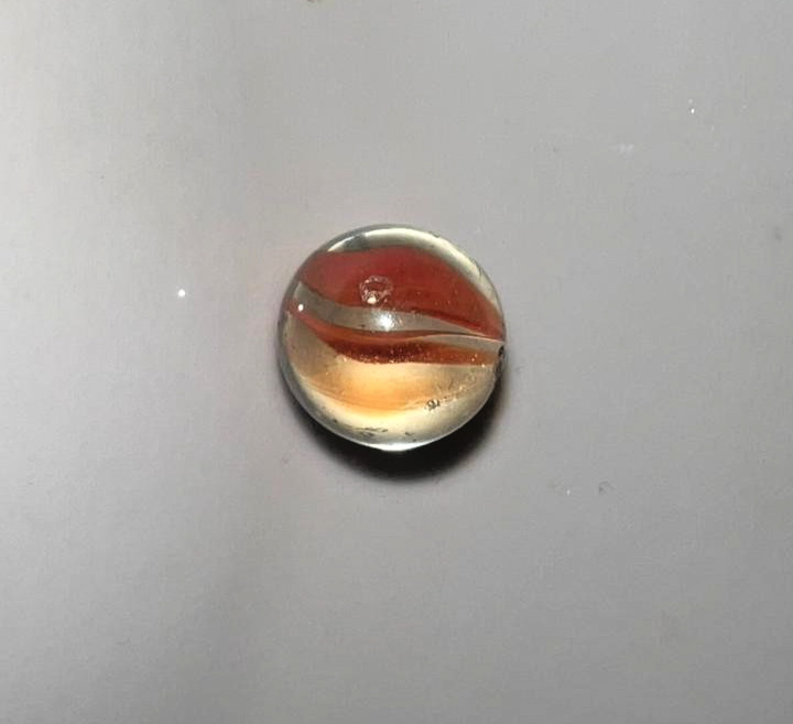 21 vintage handmade glass marbles with colorful swirls and unique patterns.