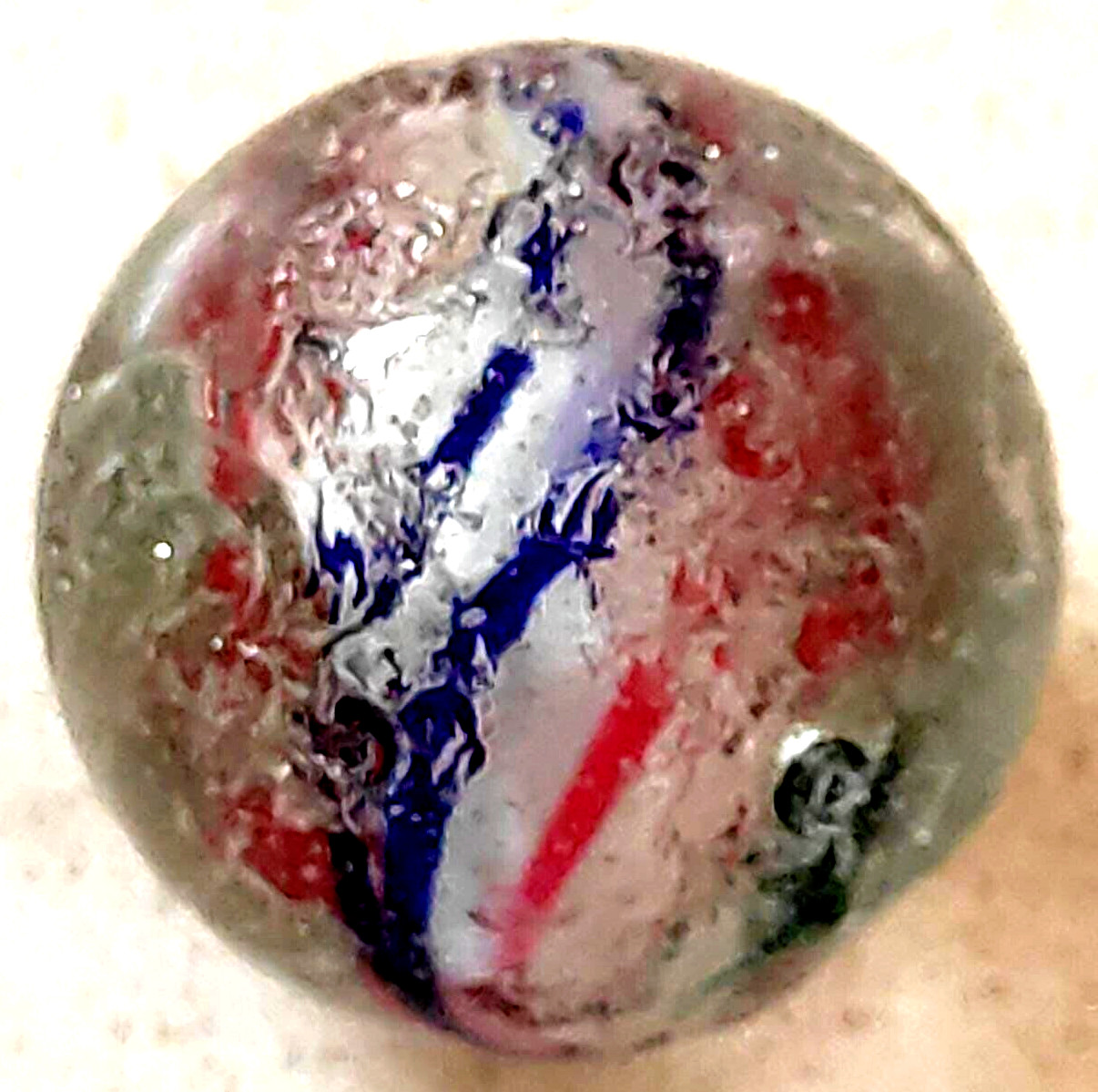 TOY MARBLE 1.1” marble trilevel ,solid core, 4 panel ribbon swirl, requ ground