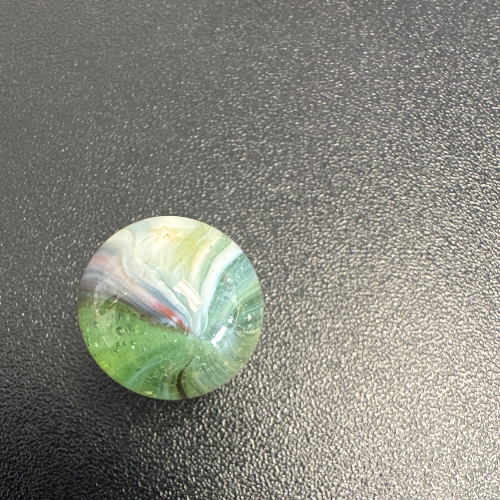 Marble. Glass. Swirl. Many colors- Green, white, blue, pinkish purple