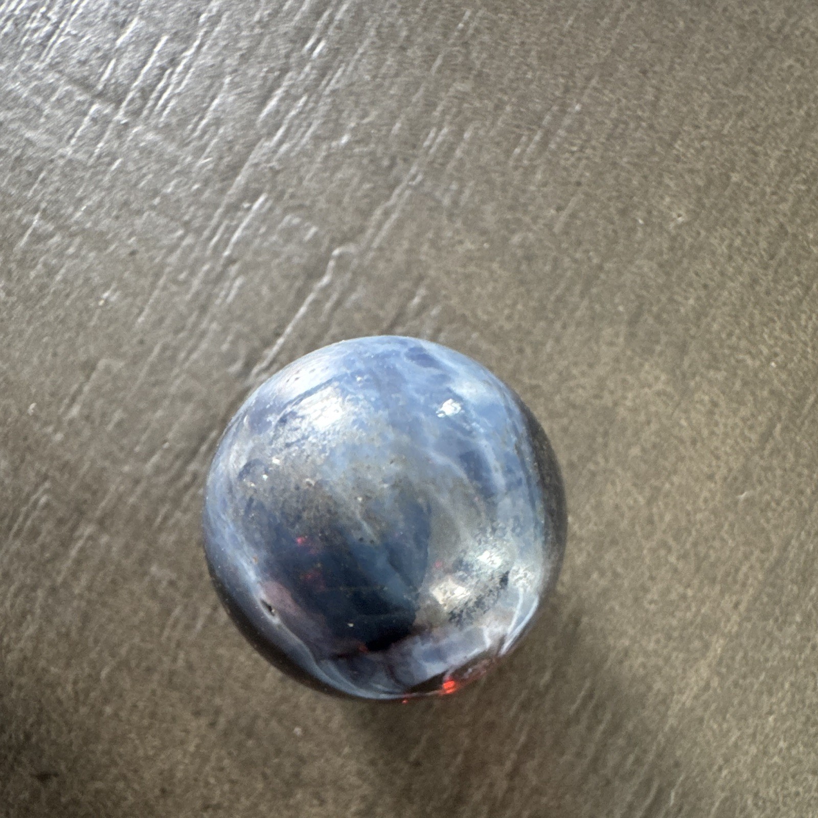 Marble. Rare looking. Glass swirl style. Dark blue/black with red.