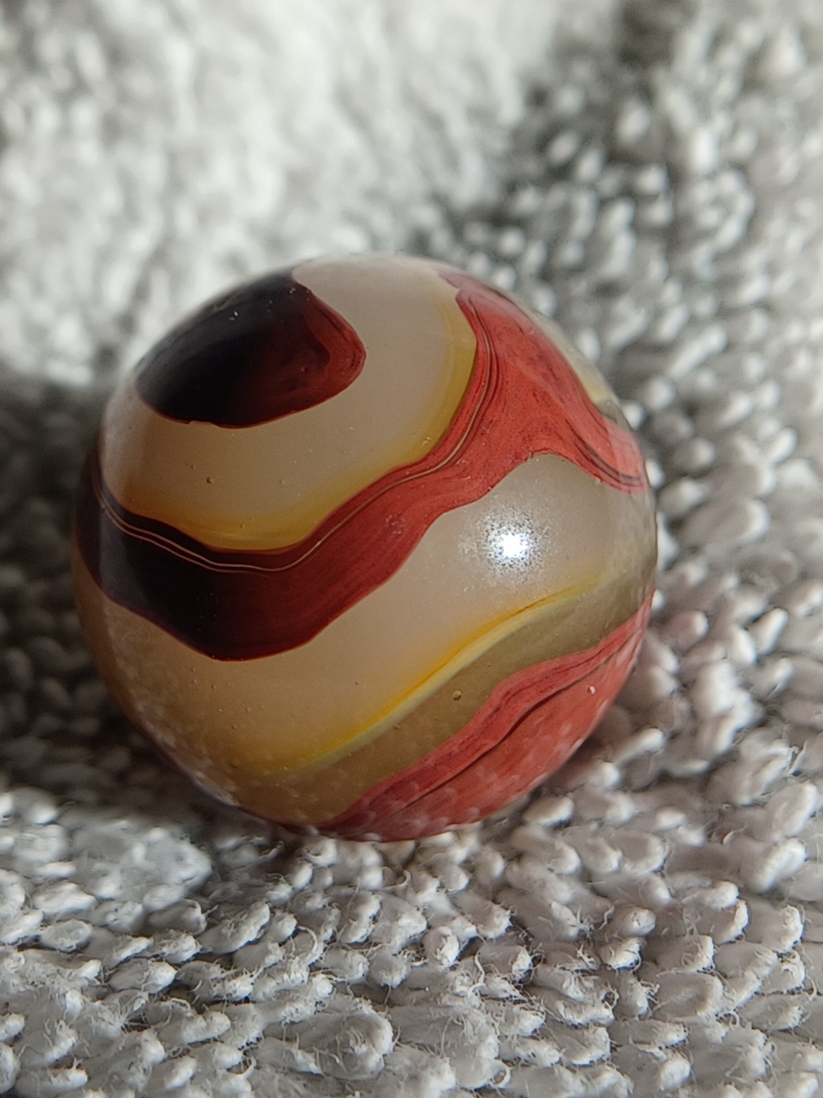 “Golden Onyx Oxblood” .70 Shiney wet dead mint. Very old and rare marble. 1920s