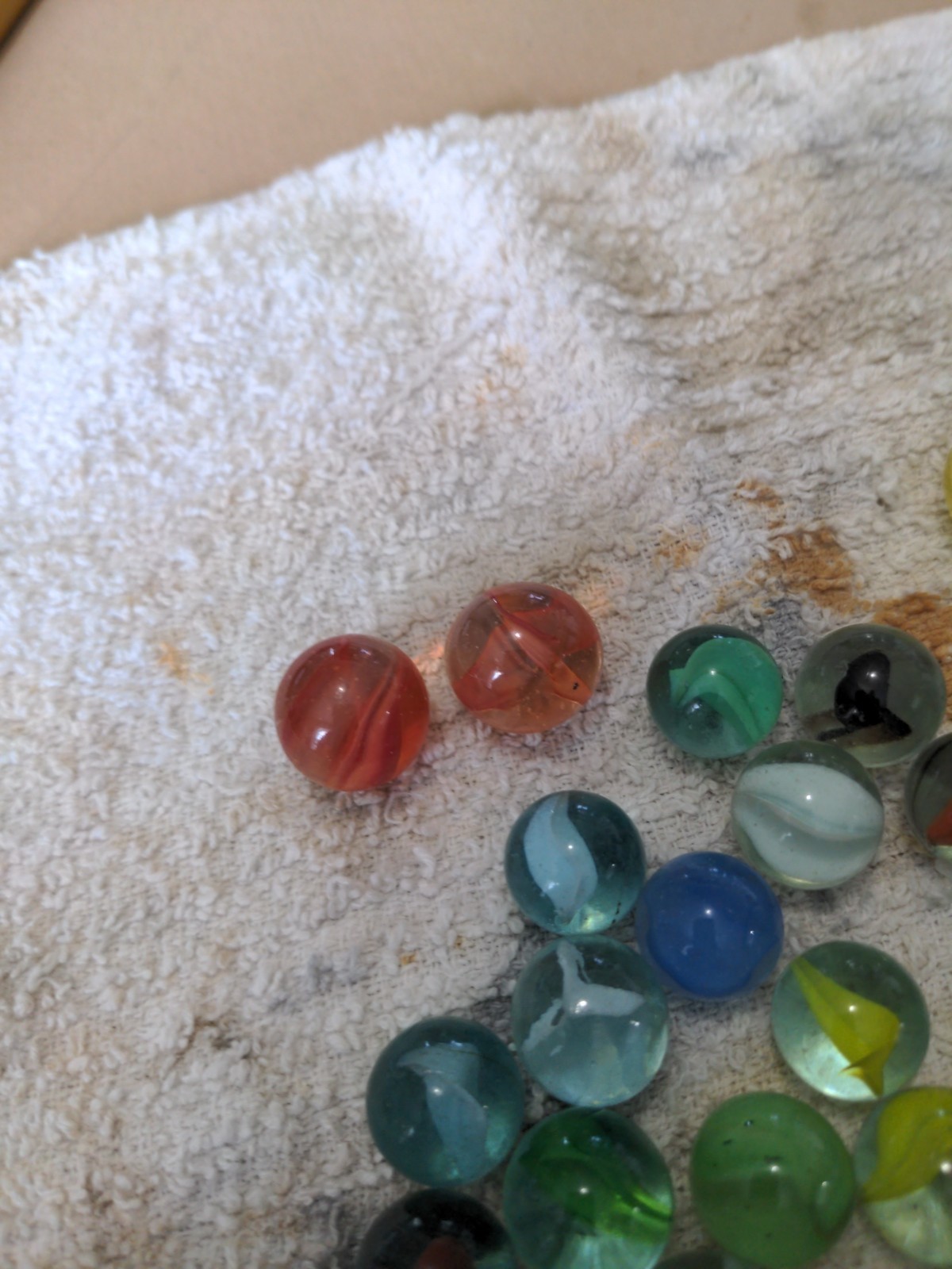 aprox. 50 cat eye marbles with 2 shooters in vintage glass bottle