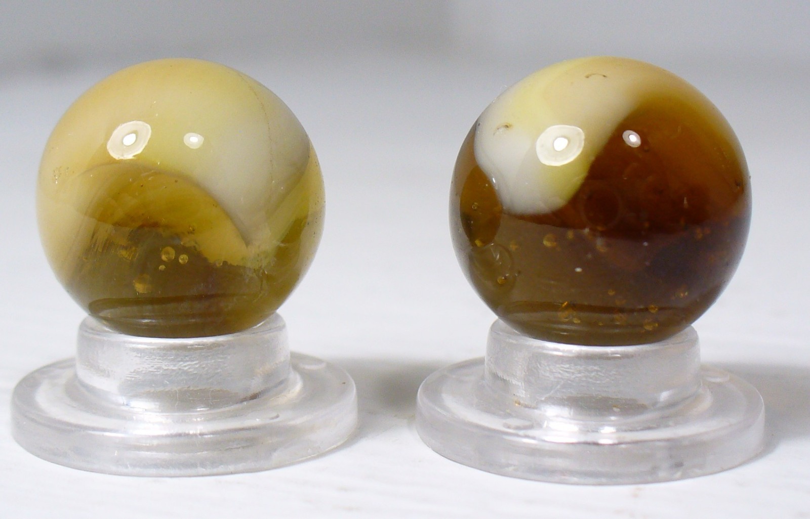 #933 Vintage 2 pcs. Amber colored Glass marbles with a White Blob inside. Root