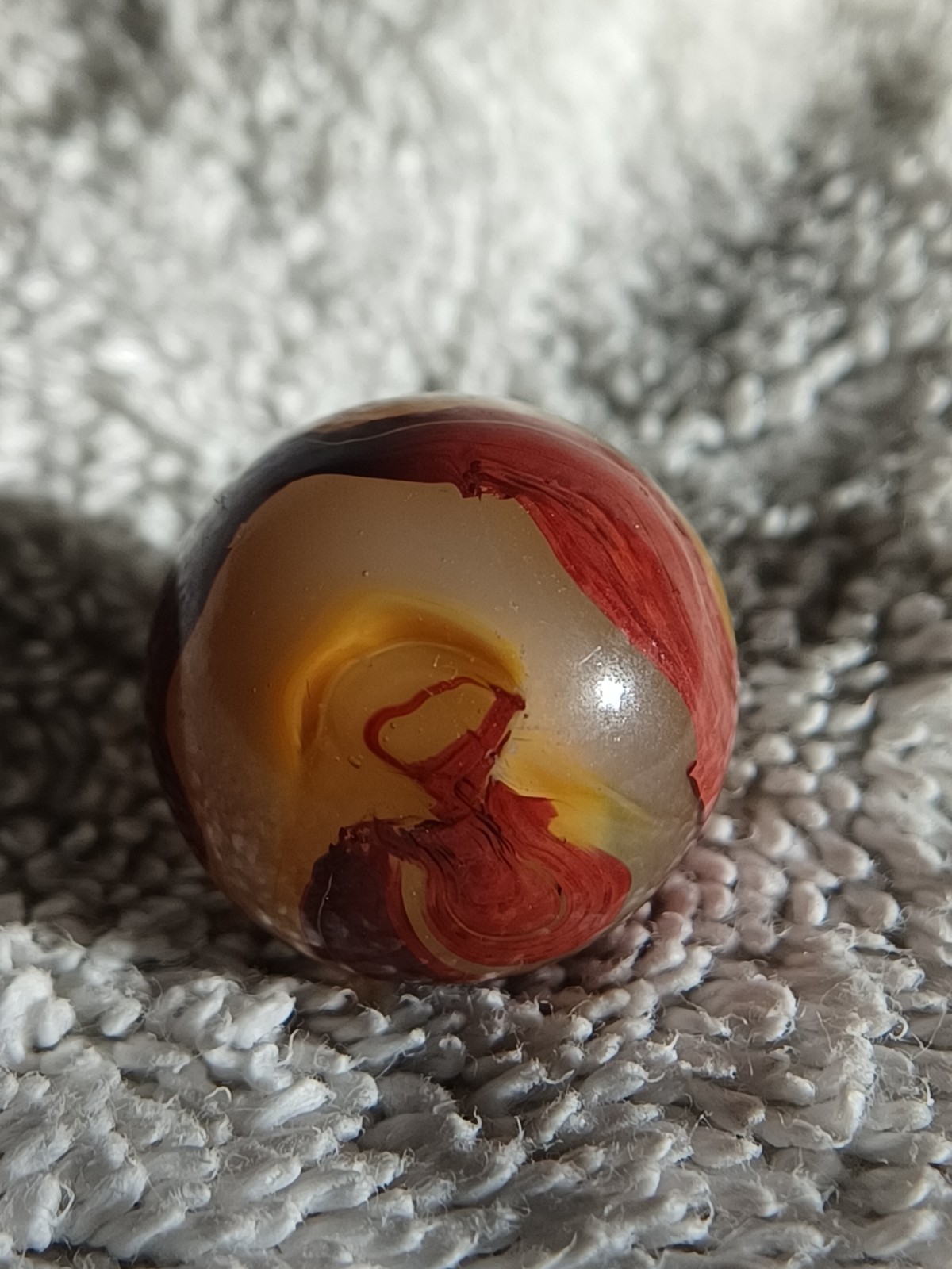 “Golden Onyx Oxblood” .70 Shiney wet dead mint. Very old and rare marble. 1920s