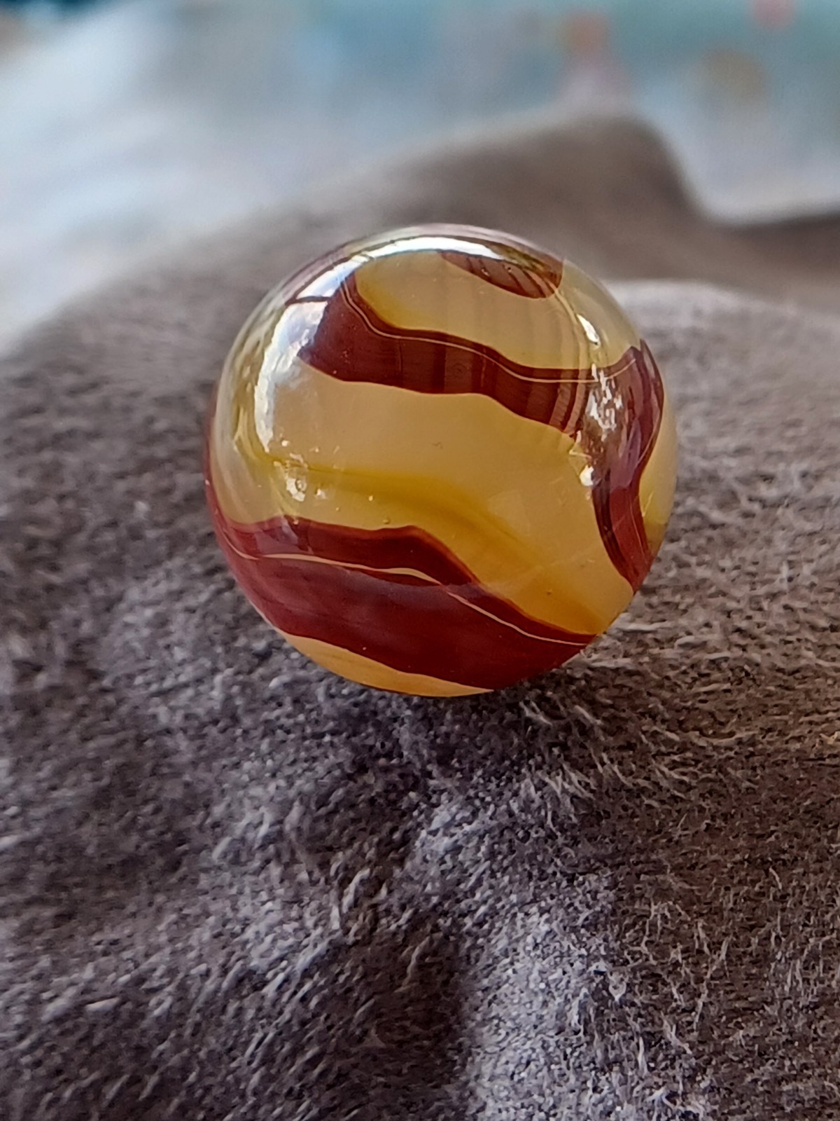 “Golden Onyx Oxblood” .70 Shiney wet dead mint. Very old and rare marble. 1920s