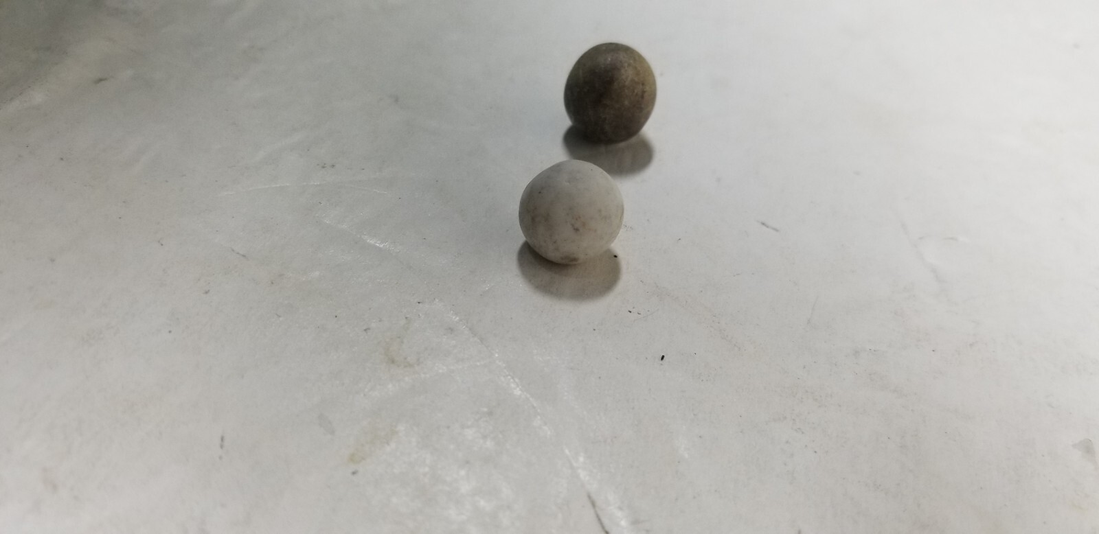 2 ANTIQUE STONEWARE MARBLES