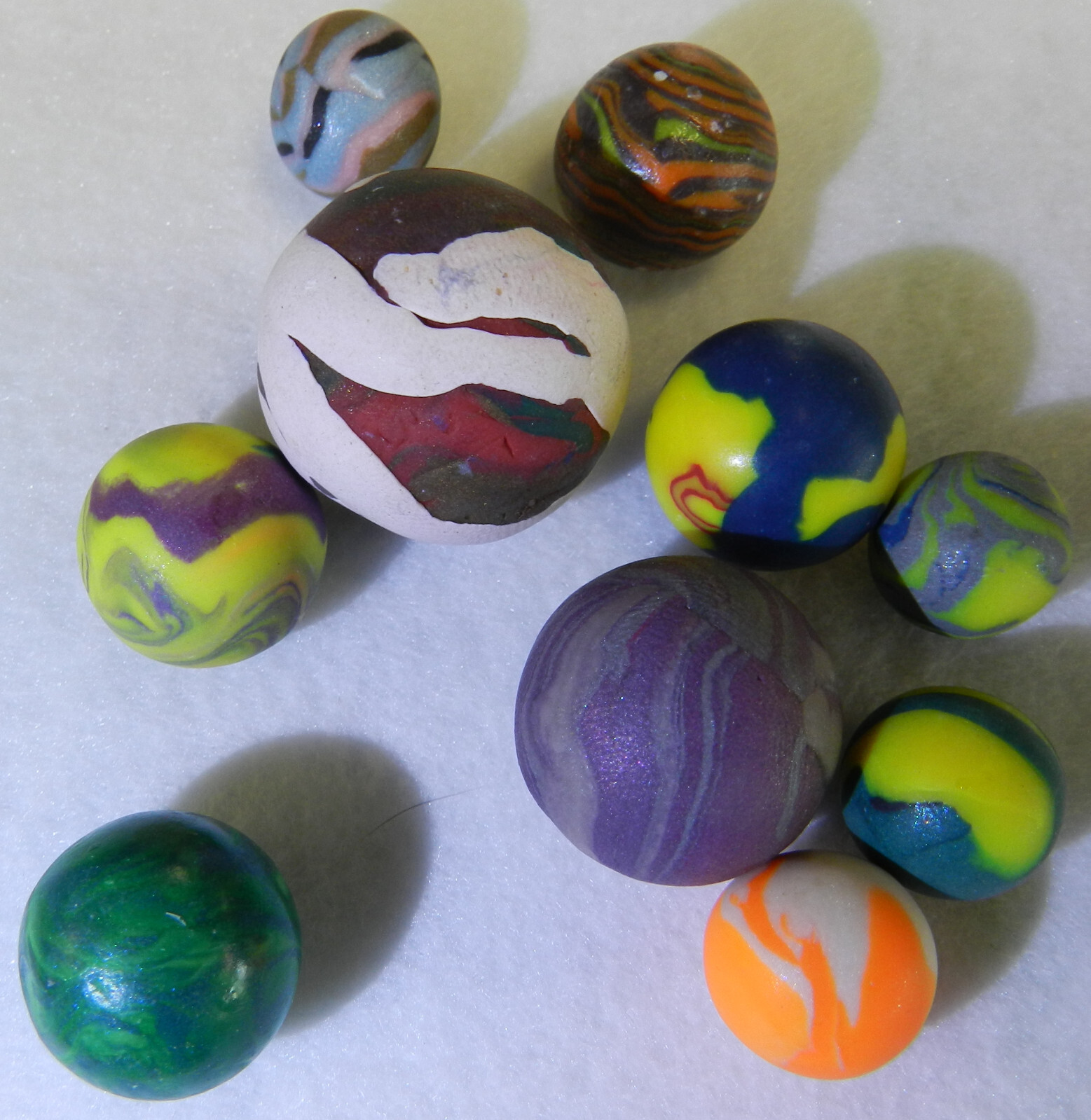 #18516m Group of 10 Unknown Artist Non Glass Marbles .57 to 1.08 Inches