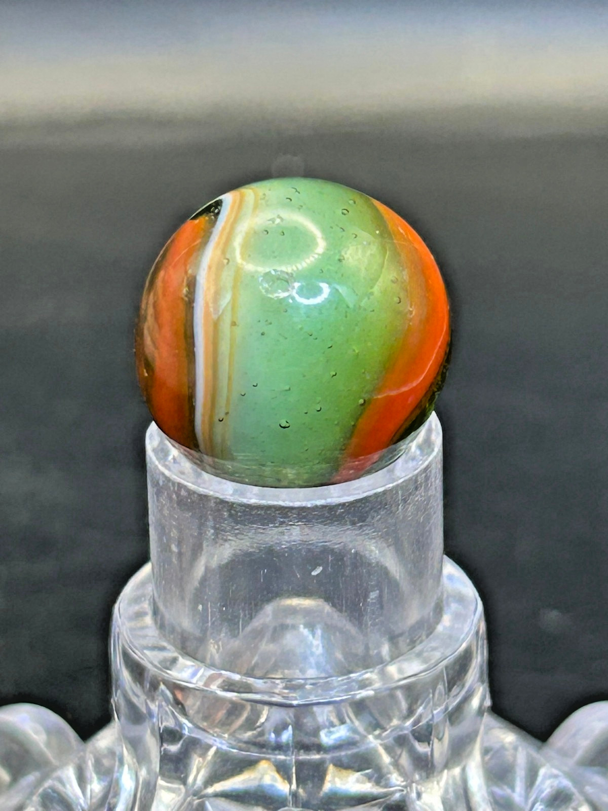 Peltier NLR Tri-Lite Marble, Green Base/Orange-Red Ribbon, UV Reactive, .63″ P28