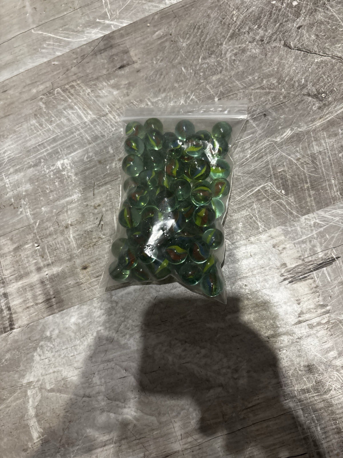 The items in the image are vintage-style glass marbles. 70 Marbles