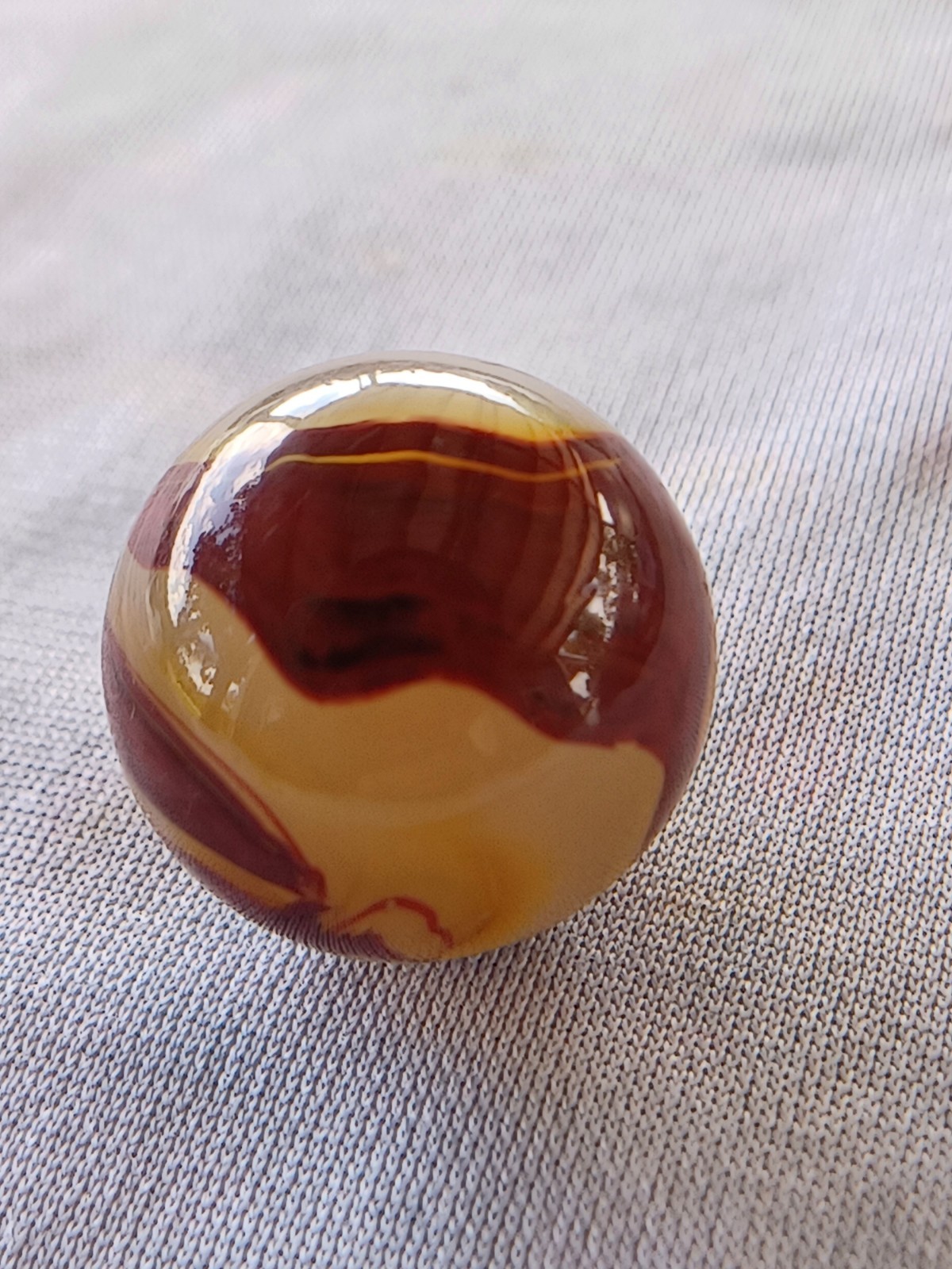 “Golden Onyx Oxblood” .70 Shiney wet dead mint. Very old and rare marble. 1920s