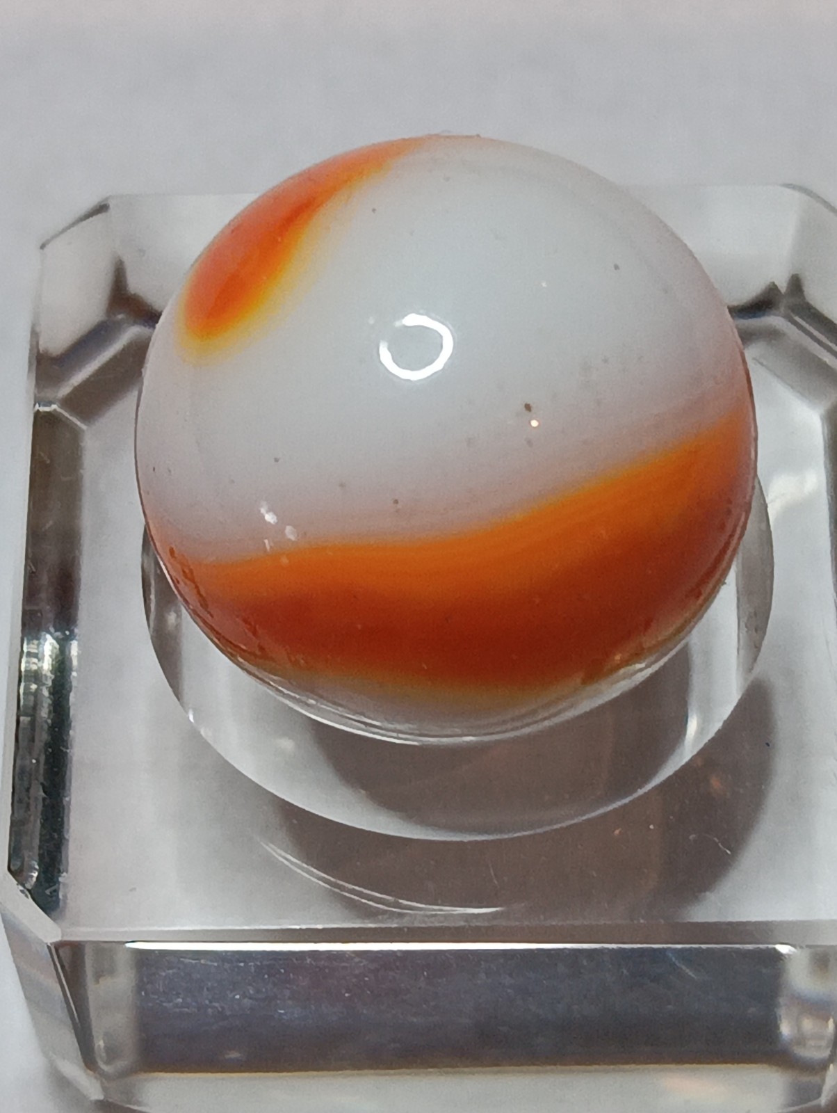 Akro Prize Name Corkscrew Marble. Mint 5/8 Inch, White Base With Orange Swirl