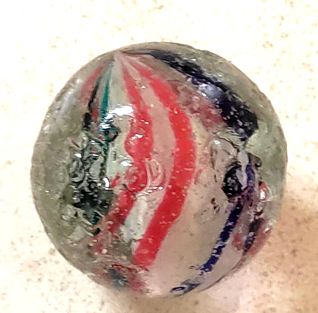 TOY MARBLE 1.1” marble trilevel ,solid core, 4 panel ribbon swirl, requ ground