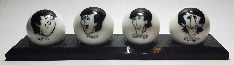 Set of 4 Cartoon Beatles Glass 1″ Logo Marbles w/ Stand