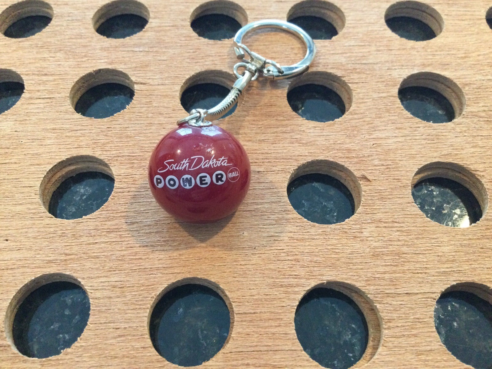 Vintage |”South Dakota Powerball”| White & Black Print on Red Marble Keychain