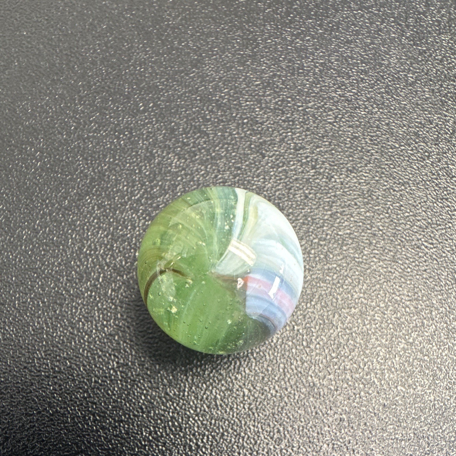 Marble. Glass. Swirl. Many colors- Green, white, blue, pinkish purple