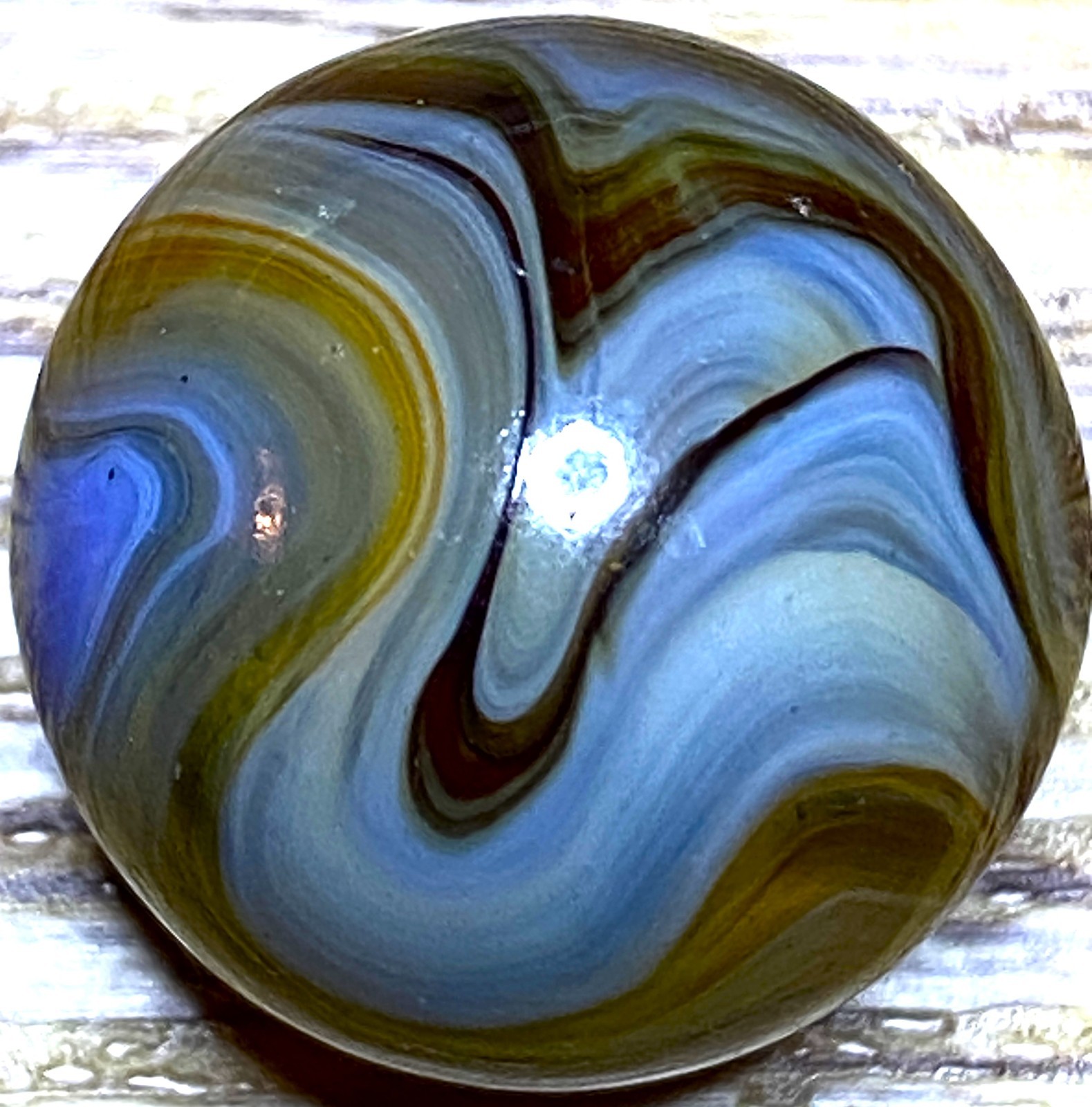 DAS/JABO WAVY BLUE AND TRANSPARENT OXBLOOD SWIRLED SHOOTER .69″ BOX03/350