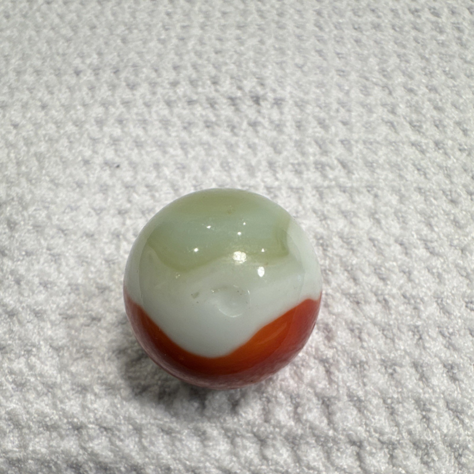 Swirl Style Glass Marble. Red, yellow and white pattern. Unique swirl design.