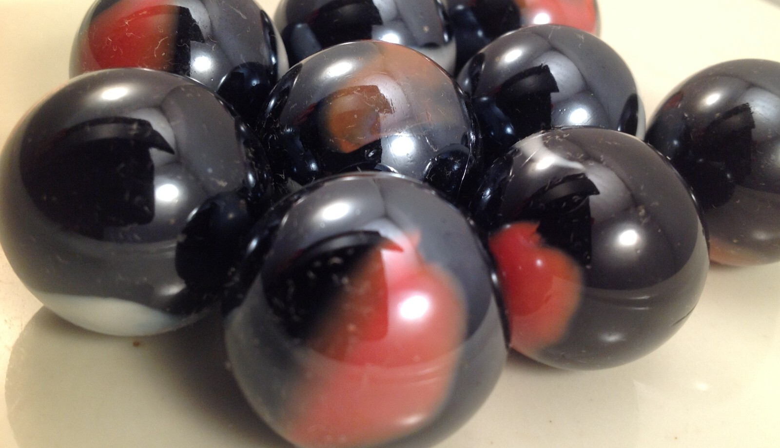 Glass Marbles 1″ – 12oz bag Black w/orange & white swirls 16pcs
