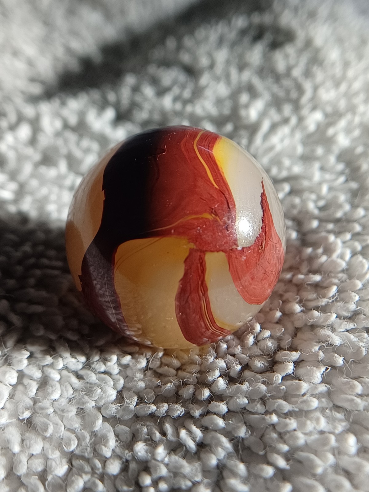 “Golden Onyx Oxblood” .70 Shiney wet dead mint. Very old and rare marble. 1920s