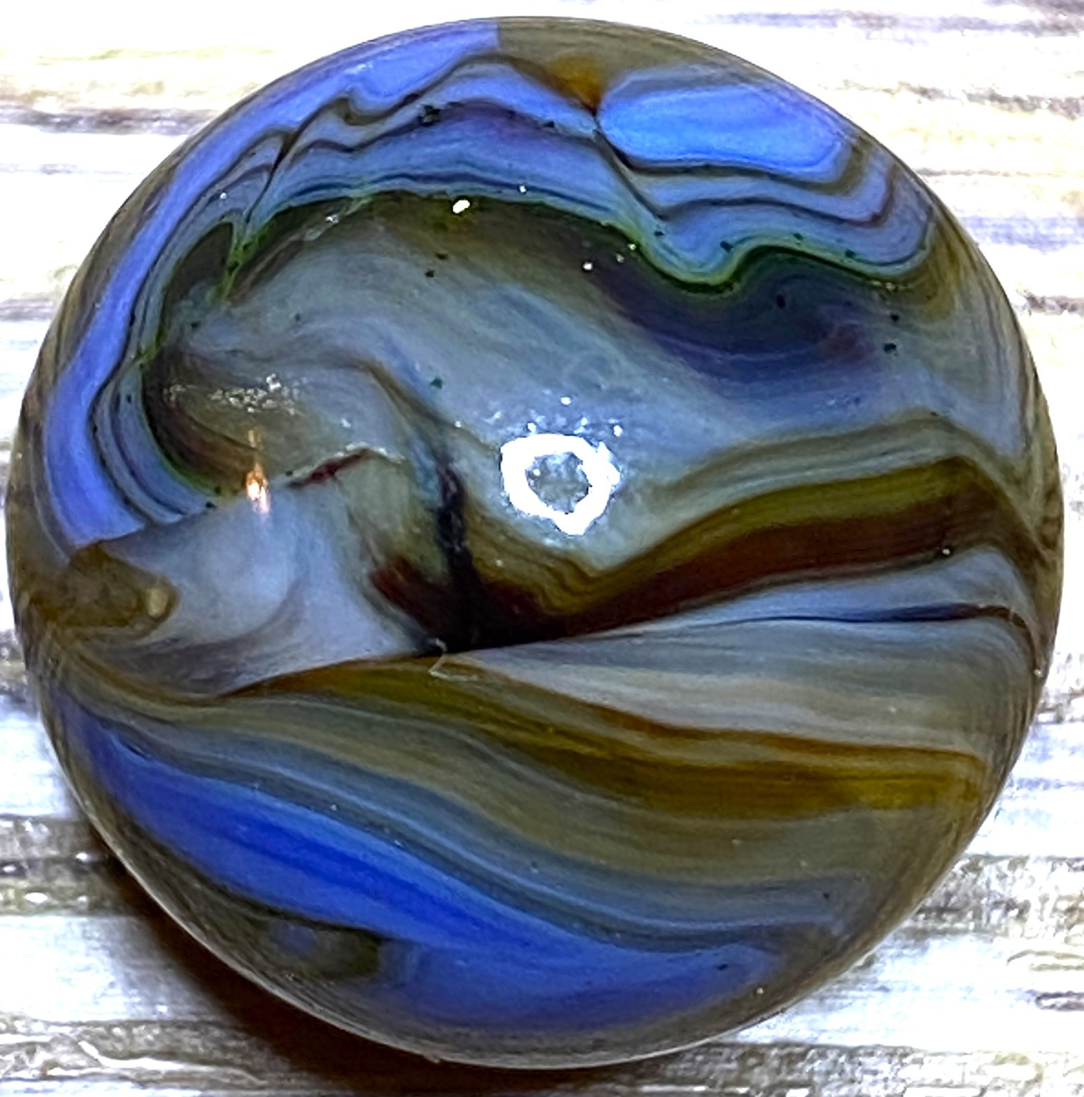 DAS/JABO WAVY BLUE AND TRANSPARENT OXBLOOD SWIRLED SHOOTER .69″ BOX03/350