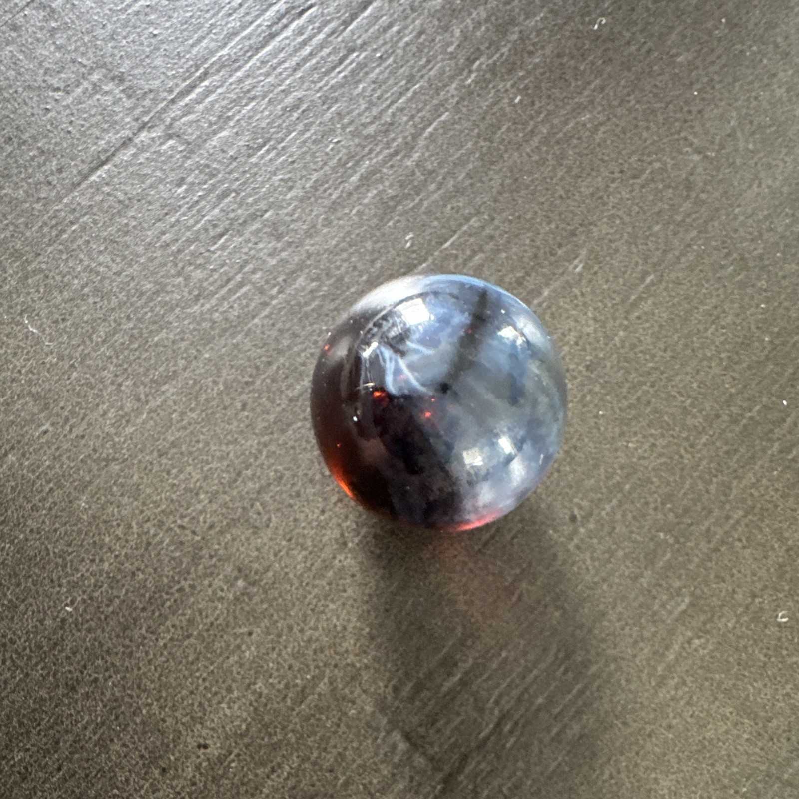 Marble. Rare looking. Glass swirl style. Dark blue/black with red.