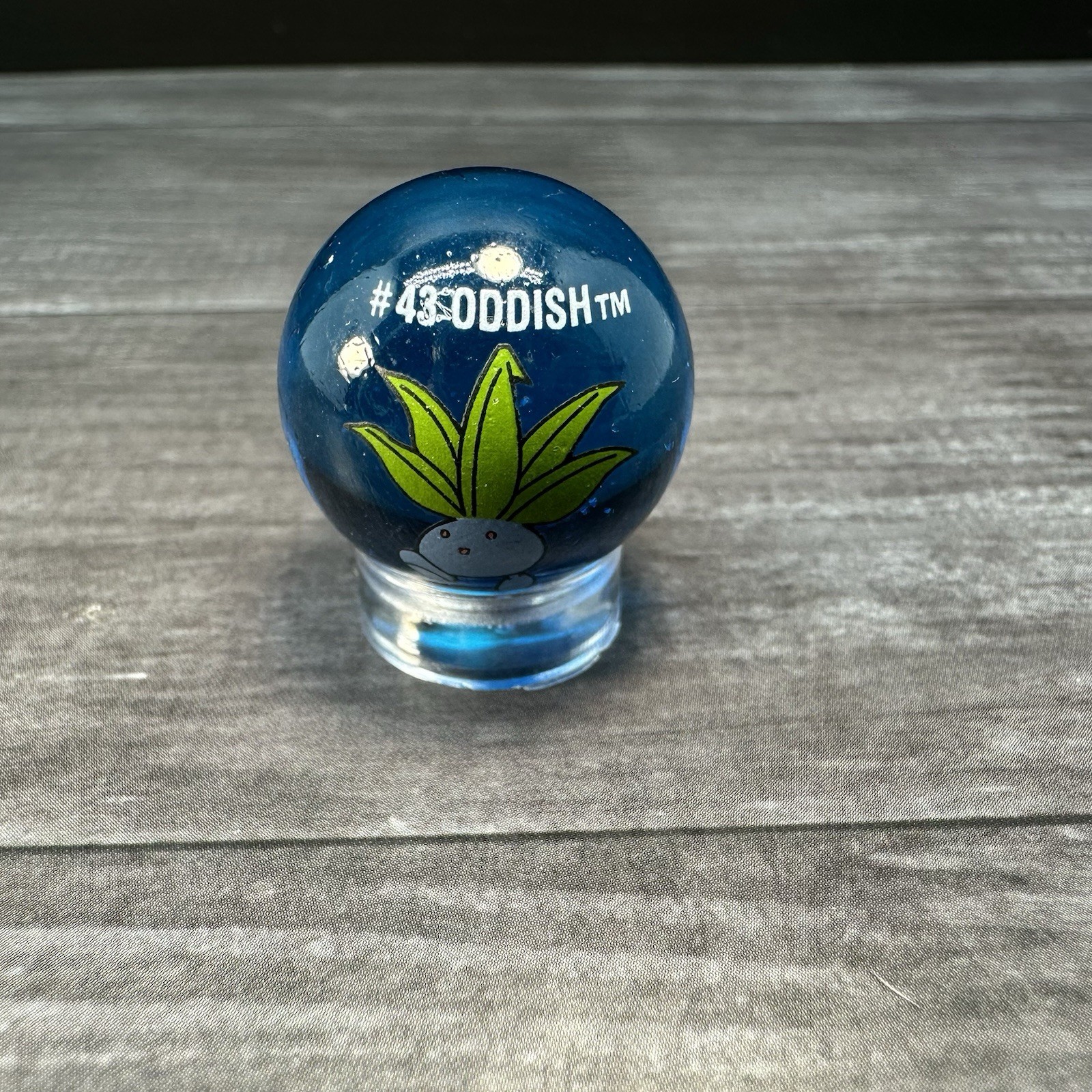 Vintage ToyBiz Pokemon Marble Oddish #43 Glass Marble Clear Blue