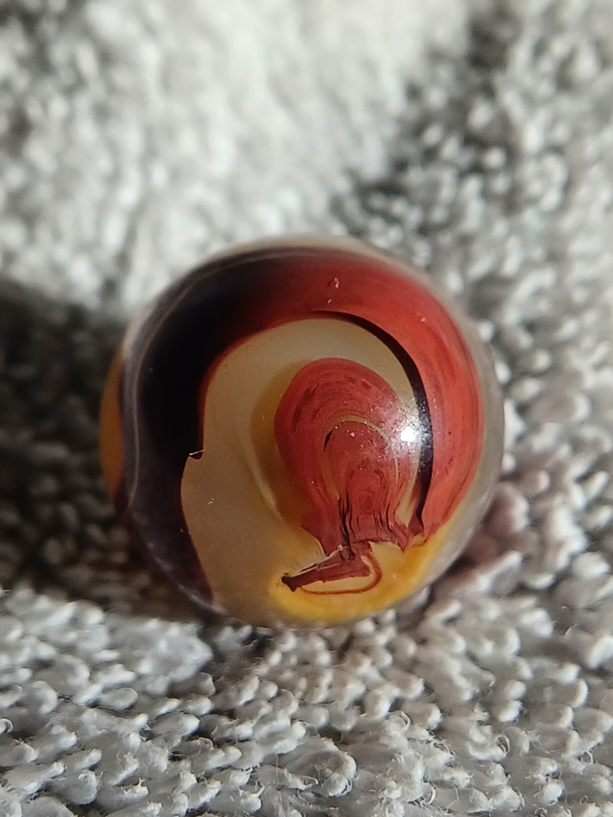 “Golden Onyx Oxblood” .70 Shiney wet dead mint. Very old and rare marble. 1920s