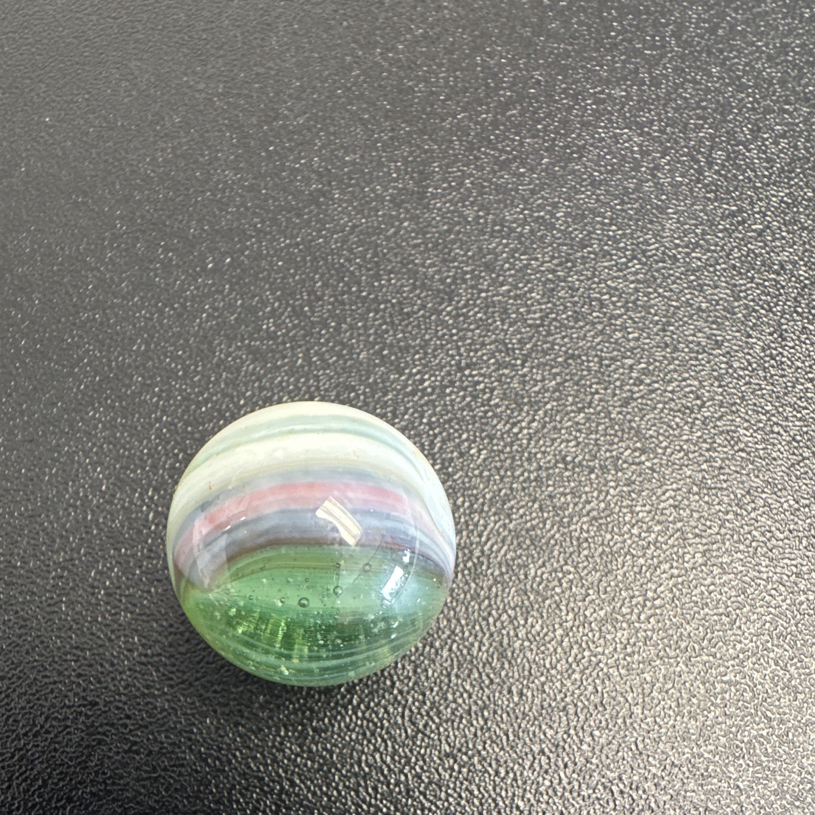 Marble. Glass. Swirl. Many colors- Green, white, blue, pinkish purple